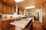 Renovated, large gourmet kitchen is well-stocked and leads into the dining area seating eight comfortably, and overlooking the mountains